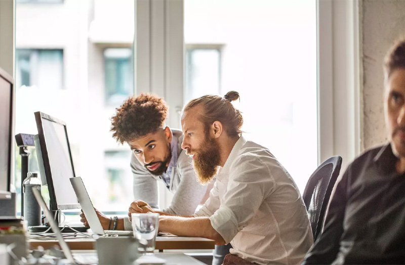 Two men looking at a computer