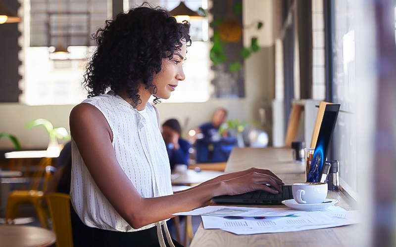 Woman using her Lenovo laptop at the coffee shop