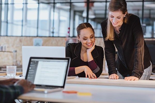 two-women-man-on-laptop-working